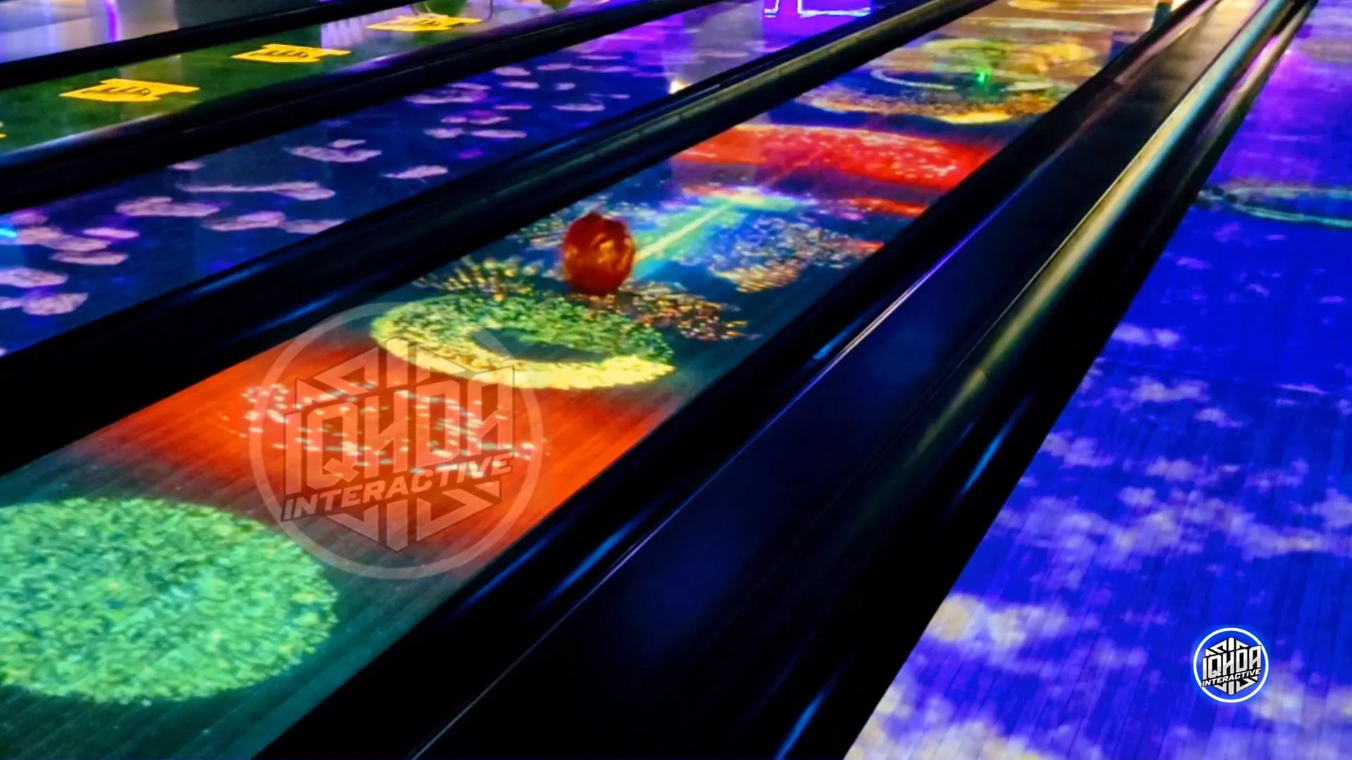 IQHDA Interactive AR bowling lane with colorful spark explosion visuals and motion-tracked bowling ball