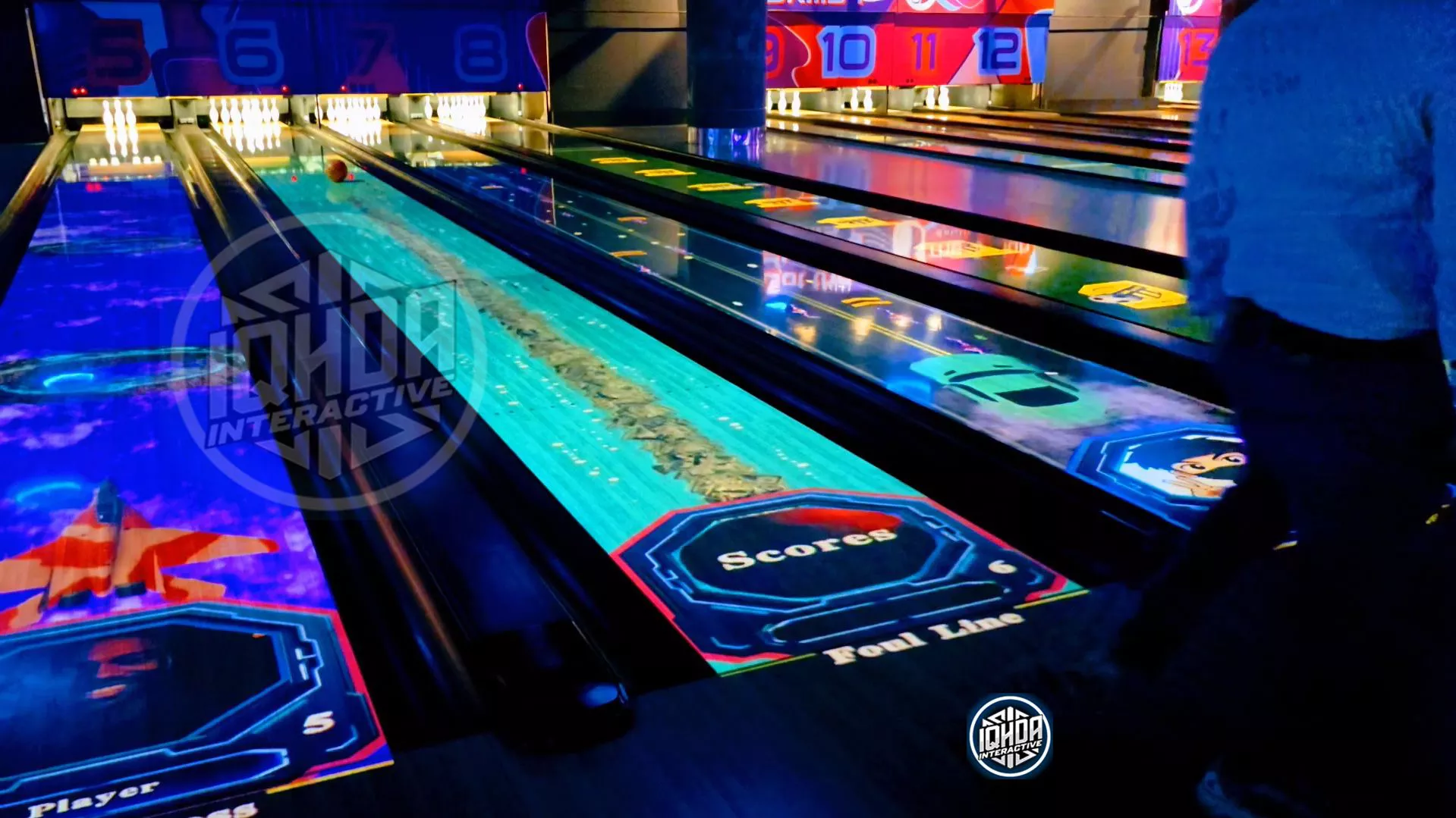 Lane 6 bowling motion tracking with projection mapping by IQHDA Interactive, surrounded by AR bowling lanes 5–13